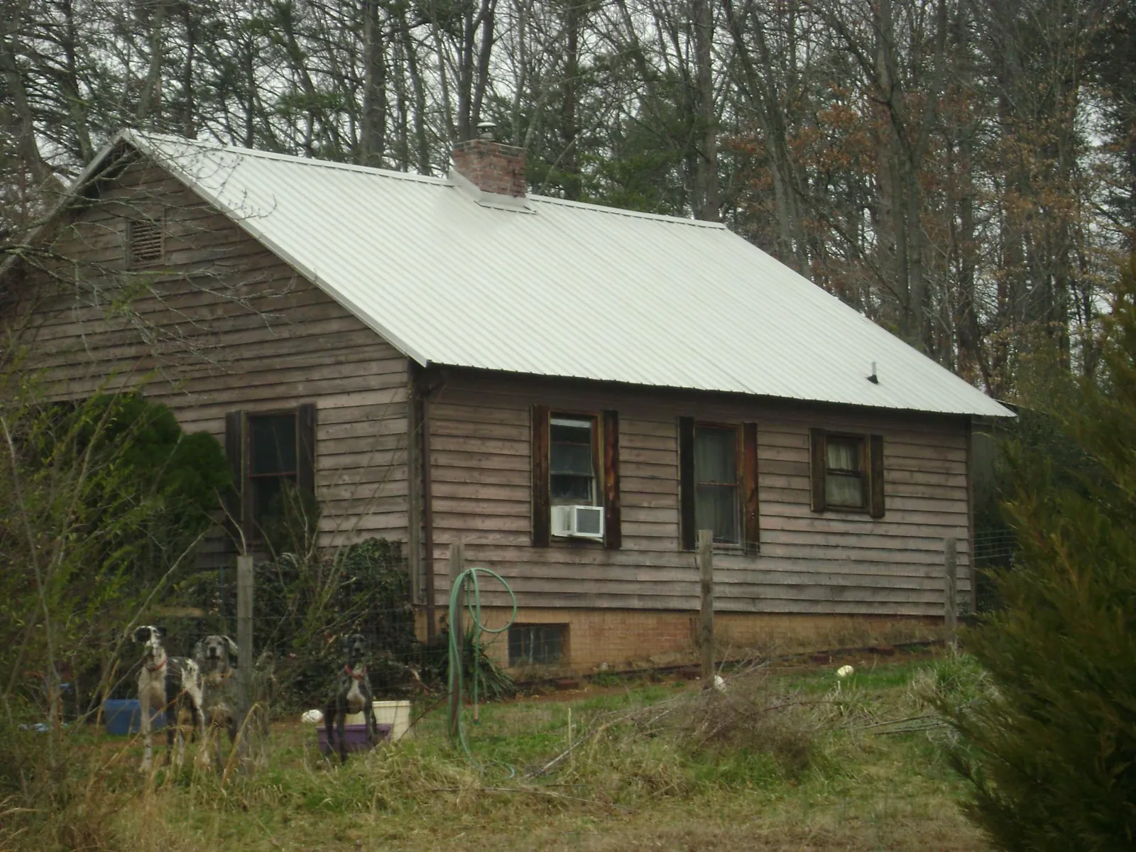 White metal roof on an old wood sided farmhouse, from a Metal Roof Installation job in Brayton